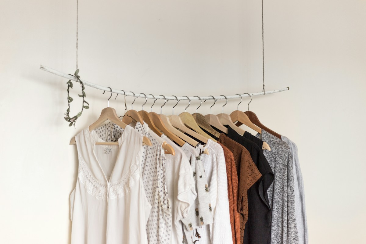 Linen and cotton clothes on a wooden clothing rail